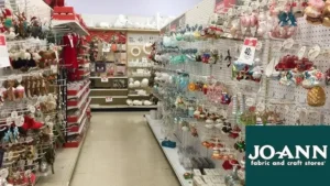 JOANN Christmas decorations shopping aisle with ornaments wreaths and holiday fabric before store closure