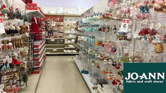 JOANN Christmas decorations shopping aisle with ornaments wreaths and holiday fabric before store closure